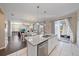 Open kitchen with granite island, stainless steel appliances, and white cabinets at 509 Powder View Dr, Ruskin, FL 33570