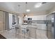 Modern kitchen with white cabinets, granite countertops, and island with seating at 509 Powder View Dr, Ruskin, FL 33570