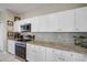 Kitchen with granite countertops, white cabinets, and stainless steel appliances at 509 Powder View Dr, Ruskin, FL 33570