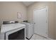 Laundry room with washer and dryer, and a white door at 509 Powder View Dr, Ruskin, FL 33570