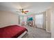 Main bedroom with king bed, ceiling fan, and large windows at 509 Powder View Dr, Ruskin, FL 33570