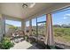 Relaxing screened porch with wicker chairs and view of backyard at 509 Powder View Dr, Ruskin, FL 33570