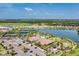 Aerial view of community with lake, pool, tennis courts, and clubhouse at 5406 Morey Farms Loop, Palmetto, FL 34221