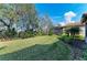 Large backyard with lush lawn and mature trees at 5406 Morey Farms Loop, Palmetto, FL 34221