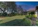 Landscaped backyard with spacious lawn and screened enclosure at 5406 Morey Farms Loop, Palmetto, FL 34221