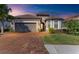One-story house with brown tile roof, gray garage door, and well-manicured lawn at 5406 Morey Farms Loop, Palmetto, FL 34221