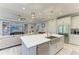 Open concept kitchen with large island, stainless steel appliances, and white cabinets at 5406 Morey Farms Loop, Palmetto, FL 34221