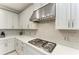 Modern gas cooktop with gray subway tile backsplash at 5406 Morey Farms Loop, Palmetto, FL 34221