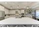 Modern kitchen with white cabinets, quartz countertops and a large island at 5406 Morey Farms Loop, Palmetto, FL 34221