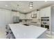 Spacious kitchen with white cabinets, quartz countertops, and stainless steel appliances at 5406 Morey Farms Loop, Palmetto, FL 34221