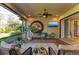 Spacious screened porch with seating area, large art piece and TV at 5406 Morey Farms Loop, Palmetto, FL 34221