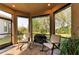Screened porch with rocking chairs and grill at 5406 Morey Farms Loop, Palmetto, FL 34221