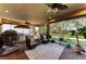 Screened porch with wicker furniture, ceiling fan, and view at 5406 Morey Farms Loop, Palmetto, FL 34221