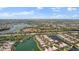 Aerial view showing community, lake, and surrounding landscape at 5521 Bilbao Pl, Sarasota, FL 34238