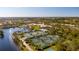 Aerial view showcasing community amenities including tennis courts and pools at 5521 Bilbao Pl, Sarasota, FL 34238