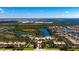 Aerial view of community, club house, tennis courts, and lake at 5521 Bilbao Pl, Sarasota, FL 34238
