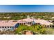 Community clubhouse with lush landscaping and clock tower at 5521 Bilbao Pl, Sarasota, FL 34238