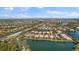 Aerial view of community with lake and numerous houses at 5521 Bilbao Pl, Sarasota, FL 34238
