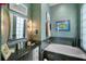 Spa-like bathroom with soaking tub, double vanity and mosaic tile at 5521 Bilbao Pl, Sarasota, FL 34238
