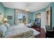 Main bedroom with king bed, relaxing sitting area, and access to a lanai at 5521 Bilbao Pl, Sarasota, FL 34238