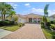 Single-Gathering home with tile roof, driveway, and landscaping at 5521 Bilbao Pl, Sarasota, FL 34238