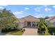 Attractive single-story home with a tile roof and landscaped front yard at 5521 Bilbao Pl, Sarasota, FL 34238