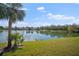 Serene lakefront view with lush landscaping at 5521 Bilbao Pl, Sarasota, FL 34238
