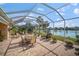 Spacious screened patio with lake view and seating at 5521 Bilbao Pl, Sarasota, FL 34238