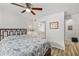 Spacious bedroom with a ceiling fan, bright windows, ensuite bathroom, and wood plank flooring at 5651 Bidwell Pkwy # 201, Sarasota, FL 34233