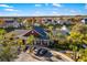 Stunning aerial view of the clubhouse with palm trees and pond with fountain at 5651 Bidwell Pkwy # 201, Sarasota, FL 34233