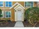 Welcoming condo front door entrance with detailed trim and cozy landscaping at 5651 Bidwell Pkwy # 201, Sarasota, FL 34233