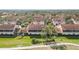 An aerial view of homes featuring tile roofs, manicured lawns, and mature trees in a well-planned community at 7254 Cedar Hollow Cir, Bradenton, FL 34203