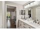 Bathroom with double vanity, black fixtures, and plenty of storage space at 7254 Cedar Hollow Cir, Bradenton, FL 34203