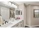Bathroom featuring double sink vanity, black fixtures, and a neutral color palette at 7254 Cedar Hollow Cir, Bradenton, FL 34203