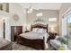 Spacious bedroom boasts ample natural light, ceiling fan, and wood-look floors at 7254 Cedar Hollow Cir, Bradenton, FL 34203
