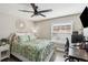 Comfortable bedroom featuring a ceiling fan, a window, and a desk setup for working from home at 7254 Cedar Hollow Cir, Bradenton, FL 34203