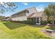 The exterior showcasing the screened-in patio and well-manicured lawn at 7254 Cedar Hollow Cir, Bradenton, FL 34203