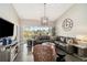 Spacious living room featuring hardwood floors, modern lighting, and comfortable seating at 7254 Cedar Hollow Cir, Bradenton, FL 34203