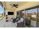 Enclosed patio with comfortable seating, a ceiling fan, and views of the green golf course at 7254 Cedar Hollow Cir, Bradenton, FL 34203