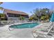 Community pool surrounded by lounge chairs and lush greenery at 7254 Cedar Hollow Cir, Bradenton, FL 34203