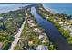 Expansive waterfront property with lush landscaping and direct access to the river and nearby beach at 7536 Midnight Pass Rd, Sarasota, FL 34242