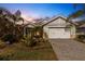 Curb appeal abounds at this charming one-story home at dusk at 8018 Sandstar Way, Sarasota, FL 34240