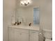 White bathroom with quartz vanity, large mirror, and toilet at 8066 Redonda Loop, Bradenton, FL 34202