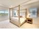 Spacious bedroom with a four-poster bed and large windows at 8066 Redonda Loop, Bradenton, FL 34202