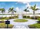 Scenic boardwalk path leading to a tranquil lake with fountain at 8066 Redonda Loop, Bradenton, FL 34202