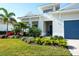House exterior showcasing landscaping and a blue front door at 8066 Redonda Loop, Bradenton, FL 34202