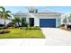 Front view of a lovely house with a blue garage door and well-manicured lawn at 8066 Redonda Loop, Bradenton, FL 34202