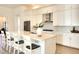 Bright kitchen with white cabinets, quartz countertops, and a large island at 8066 Redonda Loop, Bradenton, FL 34202
