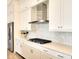 Modern kitchen with white cabinets, gas cooktop, and herringbone backsplash at 8066 Redonda Loop, Bradenton, FL 34202