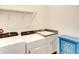 Convenient laundry room with Whirlpool washer and dryer, and granite countertop at 8066 Redonda Loop, Bradenton, FL 34202